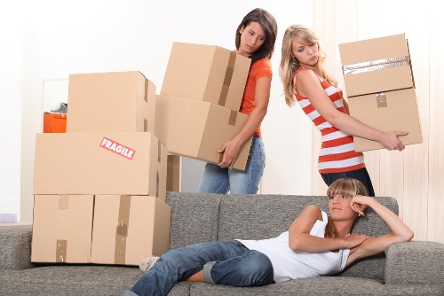 Team organizing boxes for packing services in Maidavale